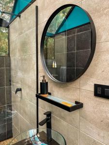 a bathroom with a mirror and a glass sink at Oasis Blue Oxapampa in Palmira +38 photos