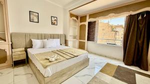 a bedroom with a large bed with a window at Casa Del Sol deluxe in Cairo