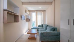 a living room with a blue couch and a table at Vera Park Premium Apart Hotel in Antalya