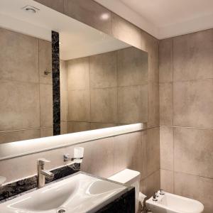 a bathroom with a sink and a mirror at Rossi Tiny in Villa Mercedes