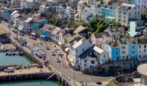 an aerial view of a city with houses and a harbor at Mariners Cottage - Wake Up to Uninterrupted Sea Views in Brixham