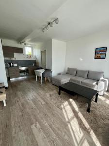 a living room with a couch and a table at Lovely Normandy - Appt en centre ville de Bayeux in Bayeux