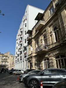 a row of cars parked in front of a building at Serenity apart by Bakuapart in Baku