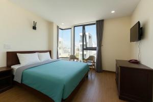 a hotel room with a bed and a television at Stars Central Danang in Danang +16 photos