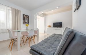 a living room with a couch and a table at Gorgeous Apartment In Novalja With Wifi in Novalja