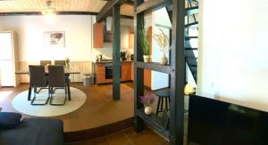 a living room and kitchen with a table and chairs at Ferienwohnung Heidezeit in Bienenbüttel