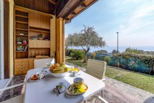 a table with a bowl of fruit on it on a patio at Villa Emma in Toscolano Maderno