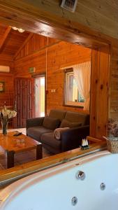 a living room with a couch and a tub at The calm west in Liman +24 photos
