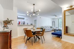 a dining room and living room with a table and chairs at Walk to CityPlace and Clematis Street Condo with Pool in West Palm Beach