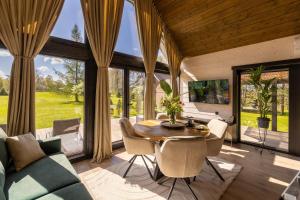 a dining room with a table and chairs and windows at Tindioru Tower Resort in Nogo