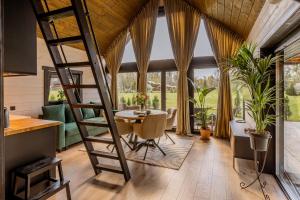 a room with a spiral staircase and a table and chairs at Tindioru Tower Resort in Nogo