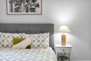 a bedroom with a bed and a lamp on a night stand at Stylish 2bed 2 bath pool & gym walk to Southern Cross in Melbourne