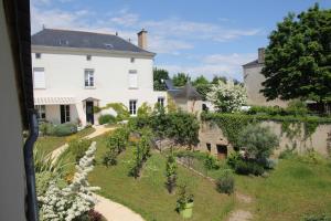 a view of a house and a garden at Doué's Mansion in Doué-la-Fontaine