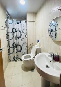a bathroom with a toilet and a sink at 8 Adriatico- 1 Bedroom Condo with Balcony in Ermita near US Embassy in Manila +18 photos