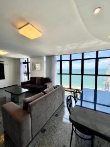 a living room with a couch and a table at Hotel Brasil Tropical in Fortaleza