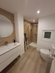 a bathroom with a sink and a toilet and a shower at Apto Espectacular Plaza España in Ferrol +12 photos