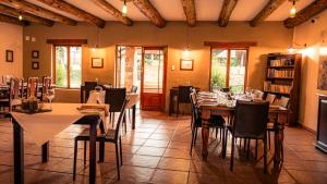 a restaurant with tables and chairs in a room at Riverbend on Komati in Machadodorp
