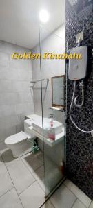 a bathroom with a toilet and a sink and a mirror at Golden Kinabalu in Kota Kinabalu +3 photos