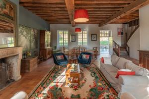 a living room with a couch and a table at La maison de l'Allier in Les Laurins