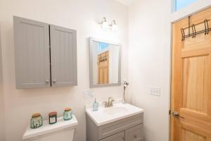 a bathroom with a sink and a mirror and a toilet at Dreamy Artist Chalet in Secluded Historic Village in Warren +41 photos