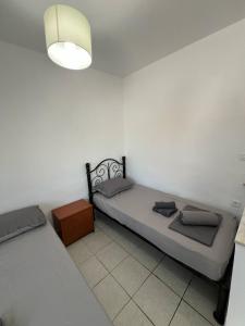 a bedroom with two beds and a lamp at Seaside Apartment in Tsonia in Tsonia