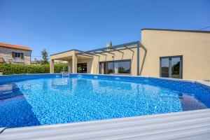a swimming pool in front of a house at Casa Mia in Rebići