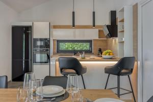 a kitchen with a table and chairs in a kitchen at Casa Mia in Rebići