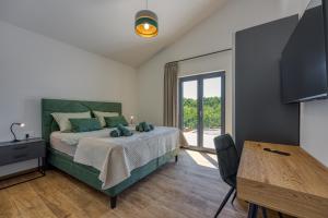 a bedroom with a large bed and a table at Casa Mia in Rebići +33 photos