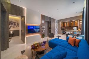 a living room with a blue couch and a table at SADEN Al-Salama in Jeddah