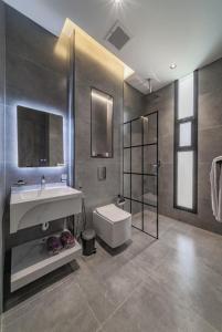 a bathroom with a sink and a toilet and a shower at SADEN Al-Salama in Jeddah