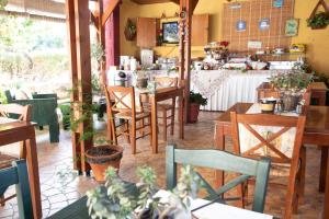 a restaurant with tables and chairs and a counter at Kos Island Studios in Kefalos