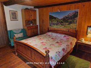 a bedroom with a bed and a painting on the wall at Rustico Cascina Val Malvaglia in Malvaglia