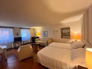 a hotel room with a bed and a living room at Pellico Apartments by Hotel America in Trento