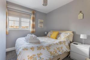 a bedroom with a bed with two towels on it at Lesbury Lodge - (a 'bijou residence') with hot tub in Alnwick
