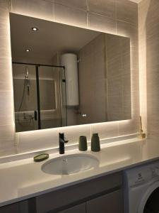 a bathroom with a sink and a large mirror at Smokinia Sunrise - Kavatsi Beach, Sozopol in Sozopol