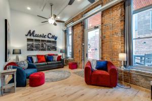 ein Wohnzimmer mit 2 Sofas und einer Ziegelwand in der Unterkunft The Majestic Lofts in Nashville