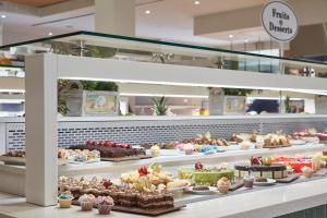 a bakery with many different types of pastries on display at Atlantica Aeneas Resort in Ayia Napa