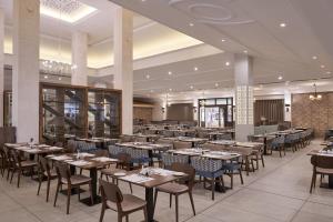 a large dining room with tables and chairs at Atlantica Aeneas Resort in Ayia Napa