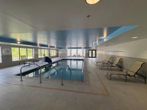 a large swimming pool in a building with chairs at Hampton Inn Bennington in Bennington