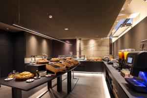 a buffet line in a restaurant with many food at Joy 124 Hotel Milano in Milan +20 photos