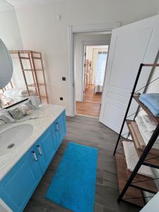 a bathroom with a blue sink and a ladder at Villa Kataraktis in Seferihisar