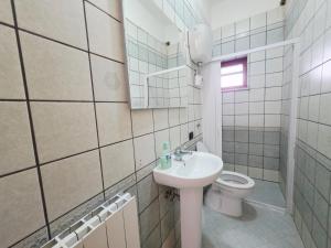 a bathroom with a sink and a toilet at VILLA I DELFINI - Terracina Fronte Mare in Lido Di Fondi +21 photos