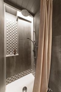 a bathroom with a shower with a shower curtain at Dimora Michelangelo in Alessano +20 photos