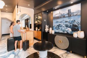 a man and a woman standing in a store at Blue Marina Suites - Boutique Apartments in Arrecife