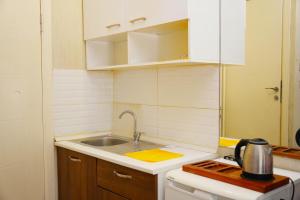 a small kitchen with a sink and a stove at Family Hotel Taksim in Istanbul