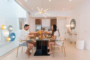 a man and woman sitting at a table in a kitchen at Blue Marina Suites - Boutique Apartments in Arrecife +108 photos