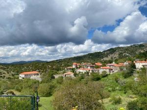 a group of houses on a hill in a village at Αγνάντιο room's in Zigovístion