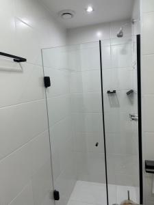 a shower with a glass door in a bathroom at SkyLux Rio Luxo com Garagem in Rio de Janeiro