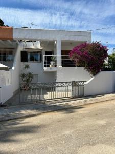 ein weißes Haus mit einem Zaun und Blumen in der Unterkunft Sun Rise in Moraira