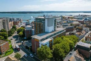 an aerial view of a city with a large building at Mojo - Modern Apartment with Balcony in Poole